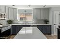 Beautiful kitchen with granite countertops, stainless steel appliances, and two-tone cabinets at 2893 W Five Mile Peak Rd, San Tan Valley, AZ 85144