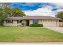 Charming single story home featuring a well-manicured lawn and a two car garage at 3010 E Cortez St, Phoenix, AZ 85028