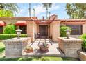 Charming front entrance with brick columns, pergola, and a cozy seating area at 3027 N Nebraska St, Chandler, AZ 85225