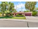 Well maintained single-story home with a lush green lawn and mature shade trees at 3027 N Nebraska St, Chandler, AZ 85225