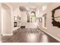 Spacious living room featuring hardwood floors, a fireplace, large windows and a staircase at 3055 N Red Mountain -- # 98, Mesa, AZ 85207