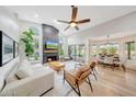 Bright living room featuring a fireplace, high ceilings, hardwood floors and access to the backyard at 306 E Sarah Ln, Tempe, AZ 85284