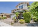 Inviting two-story home showcases a brick driveway, a two-car garage, and a front yard adorned with lush greenery and palm trees at 3422 E Strawberry Dr, Gilbert, AZ 85298