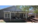 Covered backyard patio with comfortable seating, ceiling fan, and a picnic table perfect for outdoor dining at 3446 N Ravine --, Mesa, AZ 85215