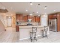 Spacious kitchen features stainless steel appliances, granite countertops, and a breakfast bar with seating at 3458 E Ivanhoe St, Gilbert, AZ 85295
