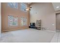 Bright living room with high ceilings, ample windows, and neutral carpet, perfect for relaxation at 3458 E Ivanhoe St, Gilbert, AZ 85295