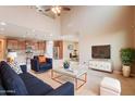 Open-concept living room boasts high ceilings, neutral tones, and seamless flow to the kitchen at 3458 E Ivanhoe St, Gilbert, AZ 85295