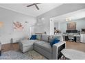 Bright living room boasts vaulted ceilings, modern furnishings, and an open layout to adjacent dining area at 3500 N Hayden Rd # 2110, Scottsdale, AZ 85251