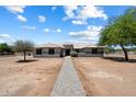 Expansive single-story home with a tile roof, desert landscaping, and a long stone walkway leading to the entrance at 3658 E Pony Track Ln, San Tan Valley, AZ 85140