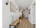 Bright hallway with wood flooring, decorative artwork, and stylish lighting fixtures at 4215 E Flower St, Phoenix, AZ 85018