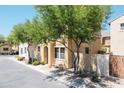 Eye-level view of two-story home with nice trees and charming curb appeal on a sunny street at 451 S Hawes Rd # 53, Mesa, AZ 85208