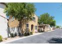 View of a two-story home showcasing its architectural design and curb appeal, set on a sunny street at 451 S Hawes Rd # 53, Mesa, AZ 85208