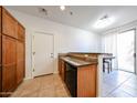 Modern kitchen area leading to a dining space with lots of natural light at 451 S Hawes Rd # 53, Mesa, AZ 85208