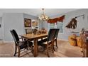 Formal dining room with wood floors, antler chandelier, and rustic western decor at 5402 E Mckellips Rd # 237, Mesa, AZ 85215