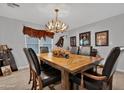 Formal dining room with wood floors, antler chandelier, and rustic western decor at 5402 E Mckellips Rd # 237, Mesa, AZ 85215
