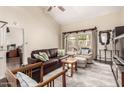 Bright living room featuring a leather sofa, large window and neutral decor with vaulted ceilings at 618 E Manzanita Pl, Phoenix, AZ 85020