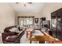 Bright living room featuring a leather sofa, large window and neutral decor with high ceilings at 618 E Manzanita Pl, Phoenix, AZ 85020