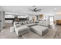 Spacious open-concept living room with a large sectional couch and seamless access to the modern kitchen at 6721 N 14Th Pl, Phoenix, AZ 85014
