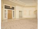 Open-concept living area boasting tile and carpet floors, tray ceilings, and a grand front door at 6917 E Night Glow Cir, Scottsdale, AZ 85266
