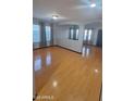Bright living room featuring sleek laminate flooring, lots of natural light, and a modern neutral color scheme at 7224 W Pioneer St, Phoenix, AZ 85043