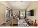 Bright living room with wood floors, slider doors, a large window, comfortable sofa, and flat screen television at 839 S Westwood -- # 287, Mesa, AZ 85210