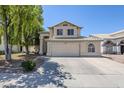 Inviting two-story home featuring a neutral color palette, large windows, and a well-maintained front yard at 869 W Shellfish Dr, Gilbert, AZ 85233