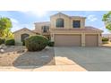 Charming two-story home featuring a spacious driveway and a low-maintenance desert landscape at 9121 E Karen Dr, Scottsdale, AZ 85260