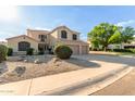 Charming two-story home featuring a spacious driveway and a low-maintenance desert landscape at 9121 E Karen Dr, Scottsdale, AZ 85260