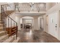 Grand foyer featuring high ceilings, staircase, and views of the dining area at 9121 E Karen Dr, Scottsdale, AZ 85260