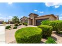 Beautiful single-story home with desert landscaping, stone accents, and a two-car garage at 9452 W Parkside Ln, Peoria, AZ 85383