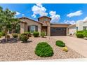 Beautiful single-story home with desert landscaping, stone accents, and a two-car garage at 9452 W Parkside Ln, Peoria, AZ 85383