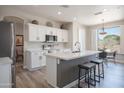 Modern kitchen featuring white cabinets, stainless steel appliances, and an island with seating at 10490 E Morning Star Dr, Scottsdale, AZ 85255