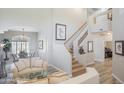 Bright, open-concept living area with high ceilings and view to dining area and staircase at 10490 E Morning Star Dr, Scottsdale, AZ 85255