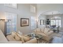 Bright living room with white walls, shuttered windows, and open-concept layout to the dining area at 10490 E Morning Star Dr, Scottsdale, AZ 85255