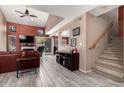 Inviting living room featuring wood-look tile, high ceilings, fireplace, and sliding glass doors at 1121 W Windjammer Dr, Gilbert, AZ 85233