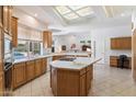 Bright kitchen featuring an island, breakfast bar, and ample counter space for cooking and entertaining at 11403 E Caron St, Scottsdale, AZ 85259