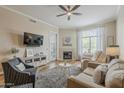 Inviting living room with plush seating, a fireplace, and a large window offering natural light at 11640 N Tatum Blvd # 2013, Phoenix, AZ 85028