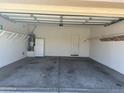 Spacious, clean garage with ample storage space, a water heater, and a side door for easy access at 11921 W Madison St, Avondale, AZ 85323