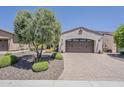 Attached two car garage with brick paved driveway and desert landscaping at 12738 W Brookhart Way, Peoria, AZ 85383
