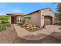 Attached two car garage with brick paved driveway and desert landscaping at 12738 W Brookhart Way, Peoria, AZ 85383