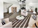 Bright, open living area featuring modern decor and an adjacent dining space with a ceiling fan for maximum comfort at 12801 N El Frio St, El Mirage, AZ 85335
