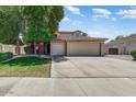 Beautiful single-Gathering home featuring a well-manicured front lawn and a spacious two-car garage at 13633 W Alvarado Dr, Goodyear, AZ 85395