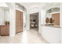 Bright foyer with tile flooring, arched doorways, and a view into the office at 15953 N 111Th Way, Scottsdale, AZ 85255