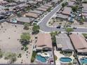 An aerial view showing many houses with pools and landscaping, in a well-planned community at 16404 S 18Th Dr, Phoenix, AZ 85045