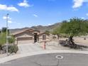 Lovely home on a corner lot with desert landscaping, lush trees, attached garage, and mountain views at 16404 S 18Th Dr, Phoenix, AZ 85045