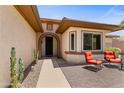 Inviting front entrance with a charming porch featuring comfortable seating and desert plants at 16716 W Rincon Peak Dr, Surprise, AZ 85387