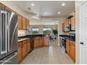 Bright and airy kitchen featuring wooden cabinets, stainless steel appliances, and granite countertops at 16716 W Rincon Peak Dr, Surprise, AZ 85387