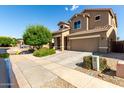 Beautiful two-story home with a two-car garage, tile roof, manicured yard and a spacious driveway at 17413 W Mandalay Ln, Surprise, AZ 85388