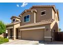 Attractive two-story home with a two car garage, tile roof, neutral colors, and inviting curb appeal at 17413 W Mandalay Ln, Surprise, AZ 85388
