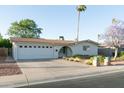 Attractive single-story home with a two-car garage and low-maintenance landscaping for a clean and inviting facade at 1894 E Julie Dr, Tempe, AZ 85283